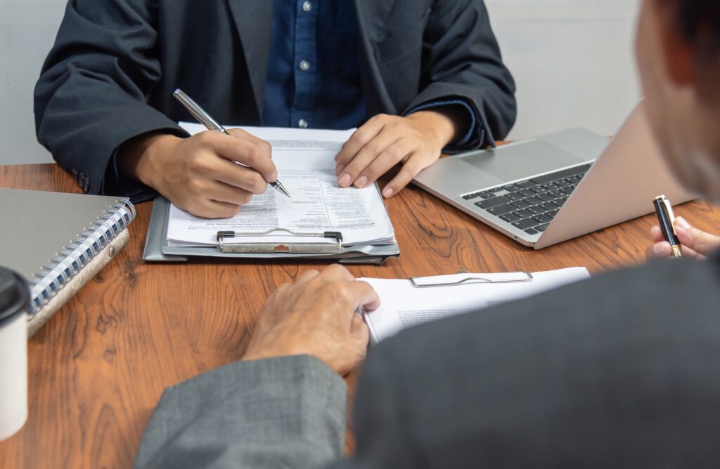 Manager or human resources is interviewing for employee job and resume application at office.